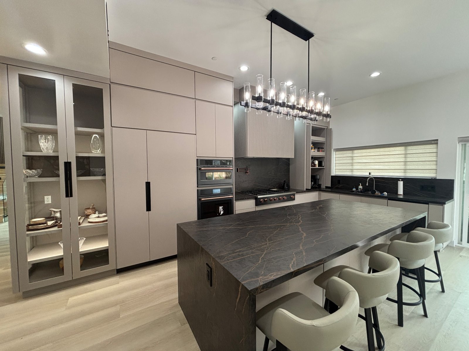 Modern flat-panel kitchen with large stone waterfall island